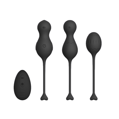 Set of black silicone kegels or massage tools with a black remote control on a transparent background